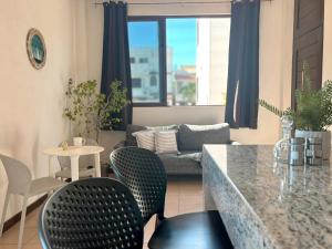 a living room with a couch and a table and chairs at Moro Apartments - Near the beach in Cancún