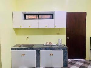 a kitchen with a counter top and a sink at Landayan Traveller Inn in Baco Medio Island