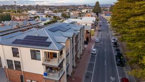 an aerial view of a city with solar panels on the roofs of houses at Harborview Modern Studio 11F in Victor Harbor +2 photos