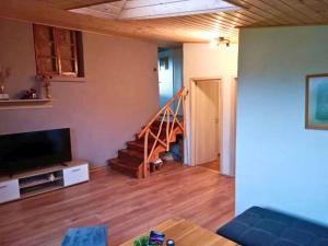 a living room with a couch and a staircase at Nachhaltiges Ferienhaus in Steinheim in Steinheim