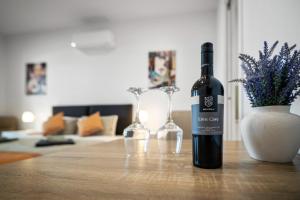 a bottle of wine sitting on a table with two wine glasses at Harborview Modern Studio 11F in Victor Harbor
