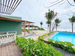 a view of a swimming pool and the ocean at Emerald Beach Homestay in Bình Sum +76 photos
