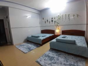a room with two beds and two rugs at LUNA House in Hue