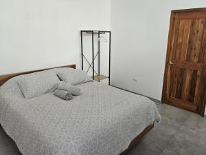 a bedroom with a bed and a wooden door at Mystica in Playa Avellana