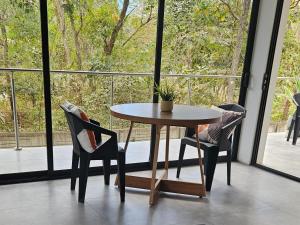 a table and chairs in a room with a window at Mystica in Playa Avellana +6 photos