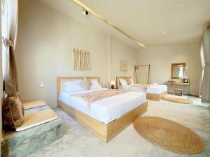 a large bedroom with two beds and two mirrors at Emerald Beach Homestay in Bình Sum
