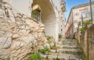 a stone alleyway in an old town with stairs at Casa Giulia 8 in Ragusa +10 photos