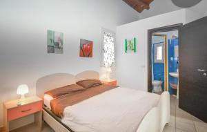 a bedroom with a large bed and a bathroom at Casa Giulia 8 in Ragusa