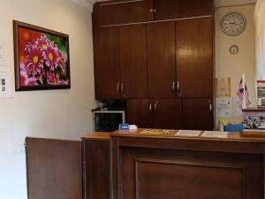 a room with a counter and cabinets and a clock at Hotel Remix 2 Cameron Highlands in Brinchang