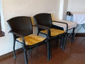 two chairs and a table in a room at Hotel Remix 2 Cameron Highlands in Brinchang