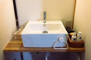 a white sink in a bathroom with a mirror at 古民家宿torch in Fujikawaguchiko +44 photos