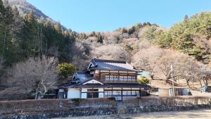 a japanese house on the side of a mountain at 古民家宿torch in Fujikawaguchiko