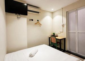 a bedroom with a bed and a desk and a table at Swing & Pillows - Sentul Jalan Ipoh Kuala Lumpur in Kuala Lumpur