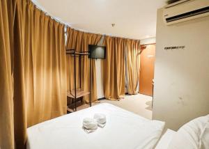a bedroom with a bed with two cups on it at Swing & Pillows - Sentul Jalan Ipoh Kuala Lumpur in Kuala Lumpur