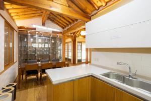 a kitchen with a sink and a dining room at HakMinJae Hanok Stay in Seoul +63 photos