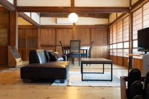 a living room with a couch and a table at 古民家宿torch in Fujikawaguchiko