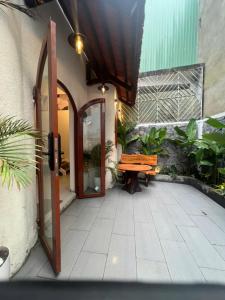 an open door to a patio with a wooden bench at Dana Home MT in Danang