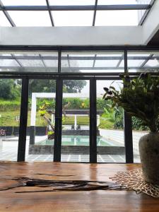 a table with a potted plant on top of it at Stella Di Mare Puncak with Private Pool 5 Bedrooms in Sampal 2