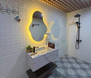 a bathroom with a sink and a mirror at Natuna Garden Villa in Ranai