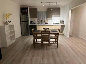 a kitchen and dining room with a table and chairs at Garden and chill in Tijuana