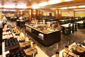 a restaurant with a buffet line with tables and chairs at Mt Fuji Hanayagi no Sho Keizan in Fuefuki