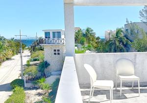 two chairs on a balcony with a view of the ocean at Moro Apartments - Near the beach in Cancún