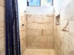 a bathroom with a shower with a window at Moro Apartments - Near the beach in Cancún +13 photos