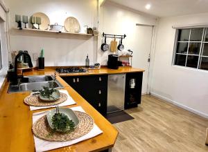 a kitchen with a sink and a counter with bowls on it at Casita Garden n chill in Tijuana +7 photos