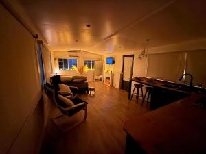 a large living room with a couch and a kitchen at Casita Garden n chill in Tijuana