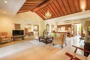 a living room with a couch and a television and a bedroom at Villa Balidamai in Kerobokan