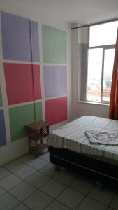 a bedroom with a bed and a window at Marlon Franca in Salvador