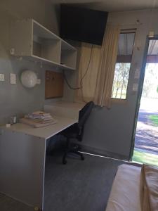 an office with a desk and a bed and a window at Cheap Rooms North Brisbane in Narangba +3 photos