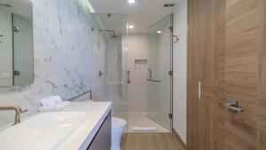 a bathroom with a shower and a sink and a toilet at Two bedroom Suite in Puerto Peñasco +4 photos
