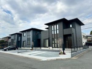 a black building with a car parked in front of it at Akikawa Koshi 12 プレミアム木造 一棟貸切ヴィラ in Yuge