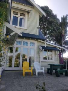 two chairs and a picnic table in front of a house at LLU Homes in Westport