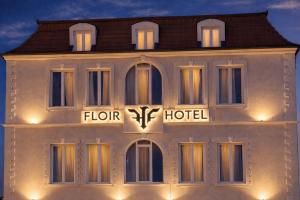 a building with a flore hotel lit up at night at Shkoder City Center - Floir Hotel in Shkodër
