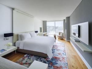 a hotel room with a bed and a tv at Rixos Premium Dubrovnik in Dubrovnik +151 photos