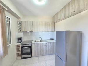 a kitchen with wooden cabinets and a stainless steel refrigerator at Casa Di Oliva 2 in Vergia
