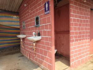 a bathroom with two sinks on a brick wall at Camping At Pawana in Malavli