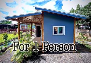 a blue house with a sign that reads for person at พีเจ คิงดอม โฮมสเตย์ in Buriram