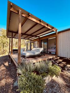 a pavilion with a bed on a wooden deck at Hilltop Haven Darlington in Darlington