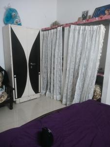 a bedroom with white curtains and a purple bed at Rajwaniya home in Jaipur