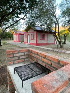 a brick bench sitting in front of a building at Las Mariposas in Merlo