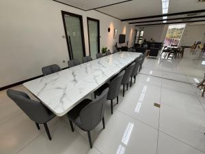 a large white marble table and chairs in a room at Flamingo Homestay Port Dickson in Port Dickson +45 photos