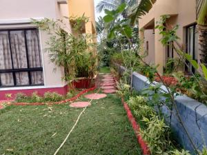 a garden in front of a house at Surabhi Gardenia 28B-C in Raichak