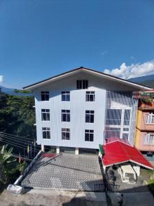 a white building with a red roof at HOTEL GREENERY VIEW in Gangtok