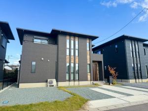 a large brick house with a blue at Akikawa Waifu 2 プレミアム木造 一棟貸切ヴィラ in Kikuchi