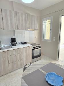 a kitchen with wooden cabinets and a table in it at Casa Di Oliva in Vergia
