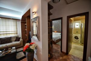 a living room with a couch and a bedroom at BMB Apartments Kotor in Kotor