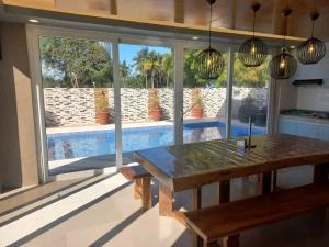 a dining room with a table and a view of a pool at Beachfront With 2 Bedrooms and Pool for 20 in San Juan